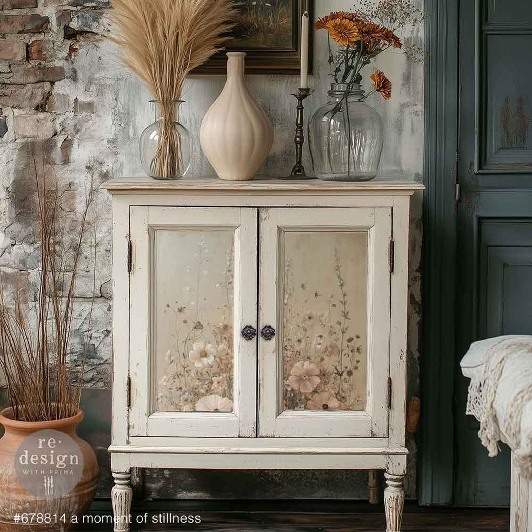 Vintage-style cabinet with floral-patterned doors against a rustic wall.