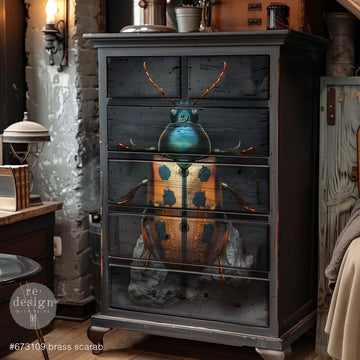 A 6-drawer dresser is painted grey and features ReDesign with Prima's Brass Scarab A1 fiber paper on the drawers.