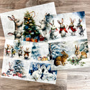 Three sheets of A3 fiber papers featuring scenes of bunnies in winter wonderlands are against a wood background.