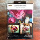 A package of ReDesign with Prima's Burst of Color A1 fiber paper is against a dark wood background.