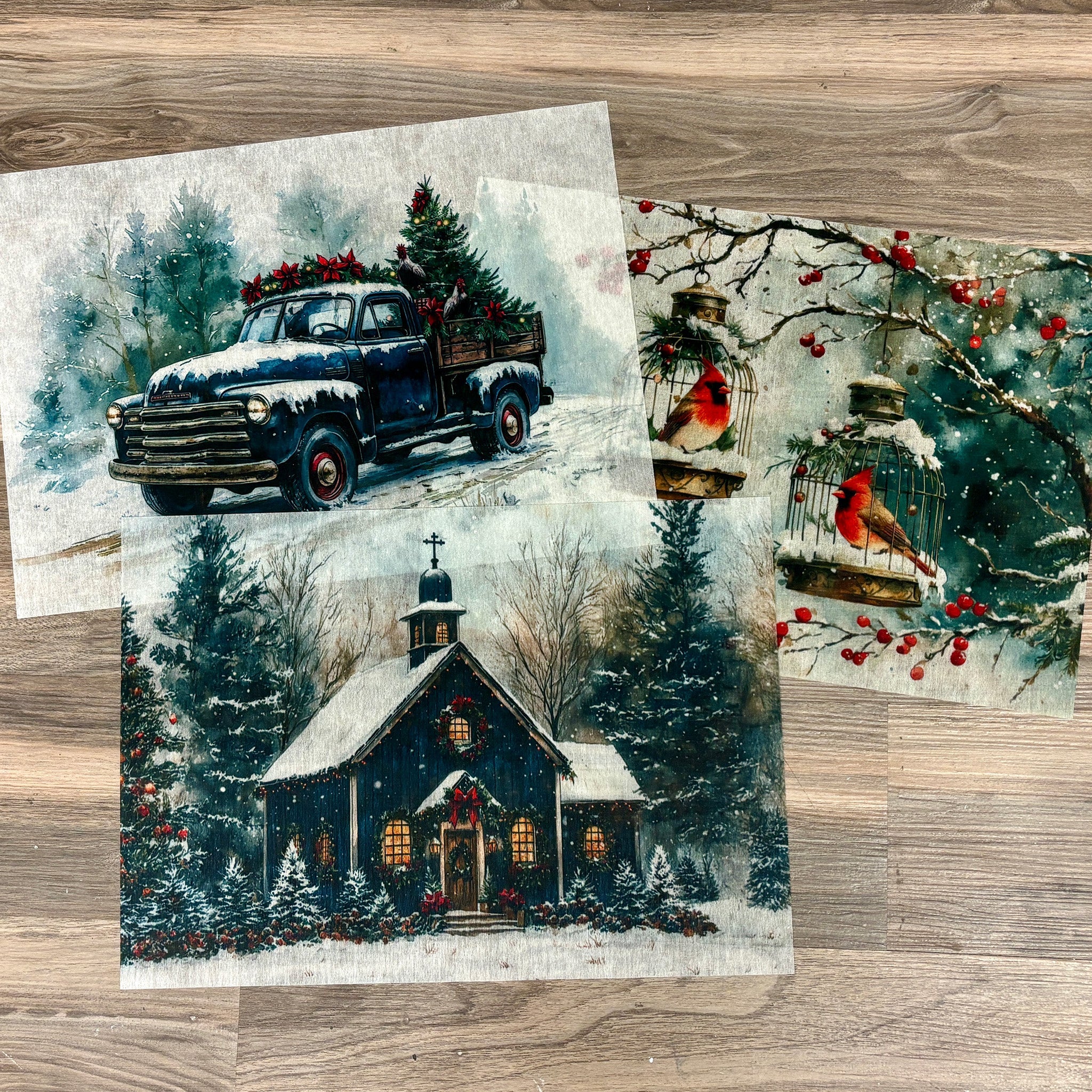 Three sheets of A3 fiber papers each with their own design featuring a charming church surrounded by snow, bright cardinals perched in cages among tree branches, and a vintage truck cruising through a snowy landscape.