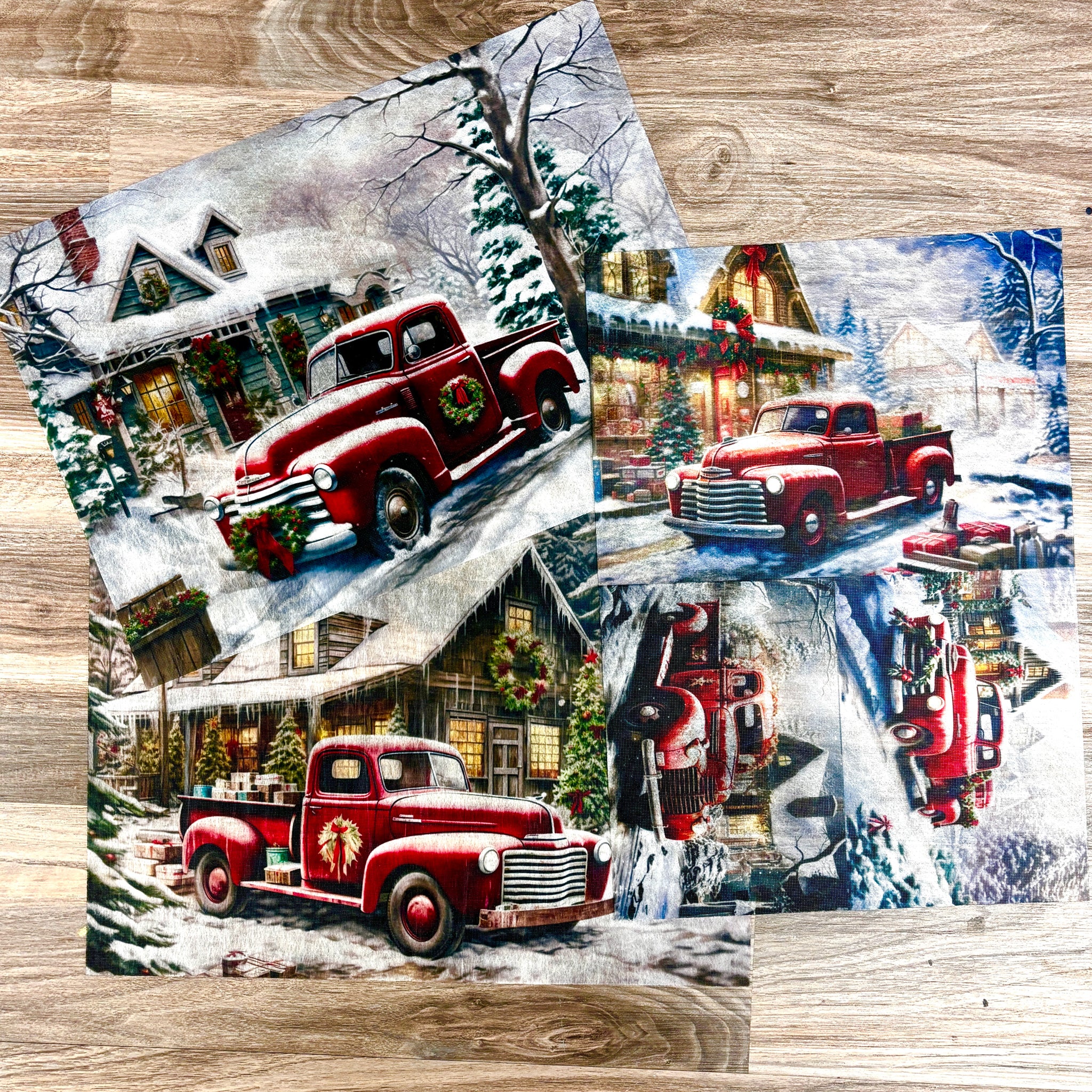 Three A3 fiber papers featuring vintage red trucks in snowy villages are against a wood background.