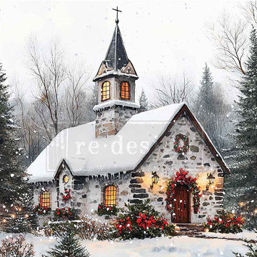Snow-covered church with festive decorations and lights, surrounded by trees.