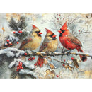 Three cardinals on a branch with snow and berries in the winter