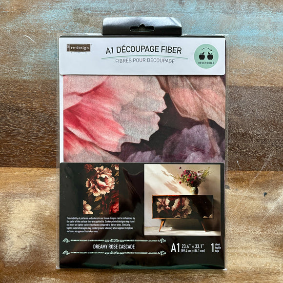 A package of ReDesign with Prima's Dreamy Rose Cascade A1 Fiber Paper is against a wood background.