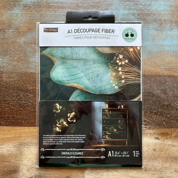 A package of ReDesign with Prima's Emerald Elegance A1 Fiber Paper is against a wood background.