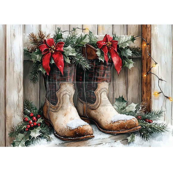 Decorative display of cowboy boots with Christmas decorations on a wooden background