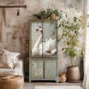 A vintage armoire with weathered grey paint features ReDesign with Prima's Frida's Essence A1 Fiber paper on its 2 top cabinet doors.