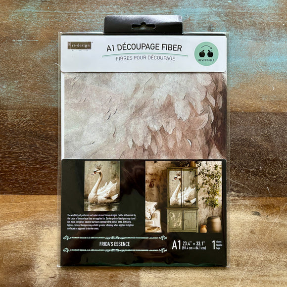 A package of ReDesign with Prima's Frida's Essence A1 Fiber Paper is against a wood background.
