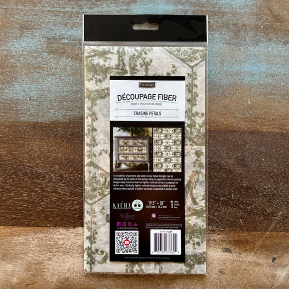 A package of ReDesign with Prima's Kacha Chasing Petals Fiber Paper is against a wood background.