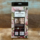 A package of ReDesign with Prima's Kacha Timeless Blooms Fiber Paper is against a wood background.