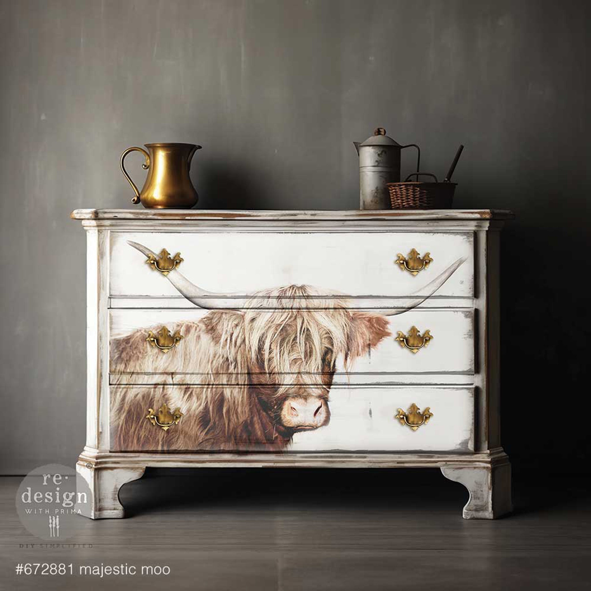 A 3-drwer dresser is painted white and features ReDesign with Prima's Majestic Moo fiber paper on the front.