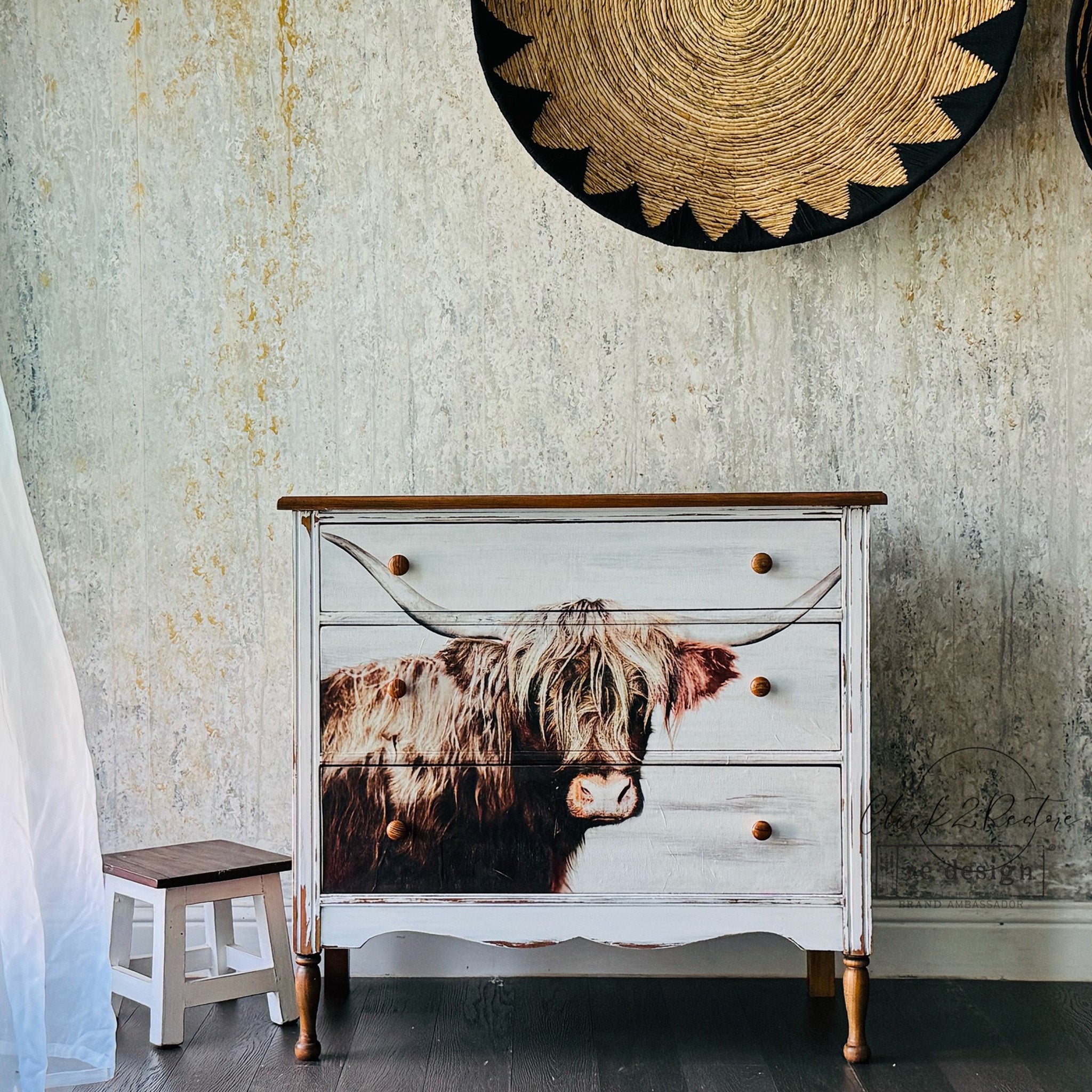 A vintage 3-drawer dresser is painted white and features ReDesign with Prima's Majestic Moo fiber paper on it.