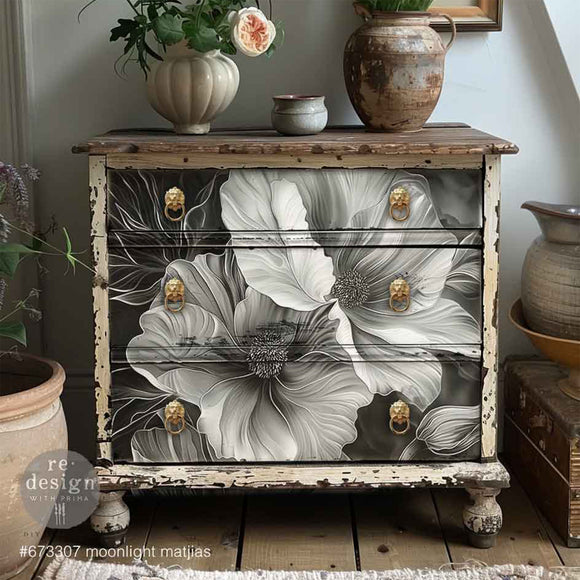 Furniture piece with floral design and gold handles in a home setting