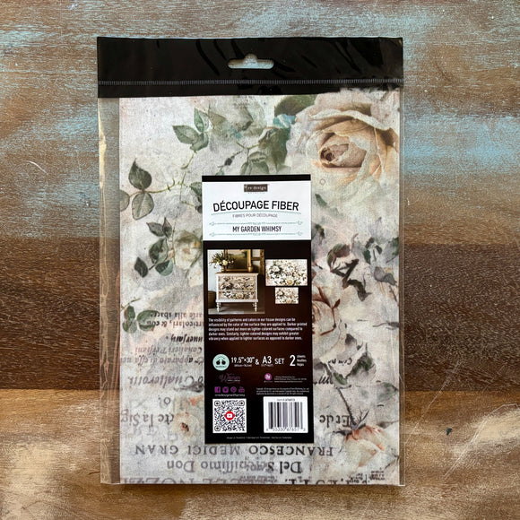 A package of ReDesign with Prima's My Garden Whimsy Fiber Paper is against a wood background.