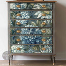 Furniture with floral pattern and gold knobs on a plain background