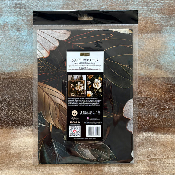 Packaging of Decoupage Fiber on a decorative background with floral designs.