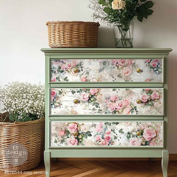 A 3-drawer chest dresser is painted light sage green and features ReDesign with Prima's Rosy Reverie Fiber paper on the drawers.