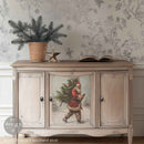 A vintage buffet cabinet is natural wood with white wash paint and features 1 design of Santa from ReDesign with Prima's Santas Woodland Stroll A3 fiber paper in the center door.