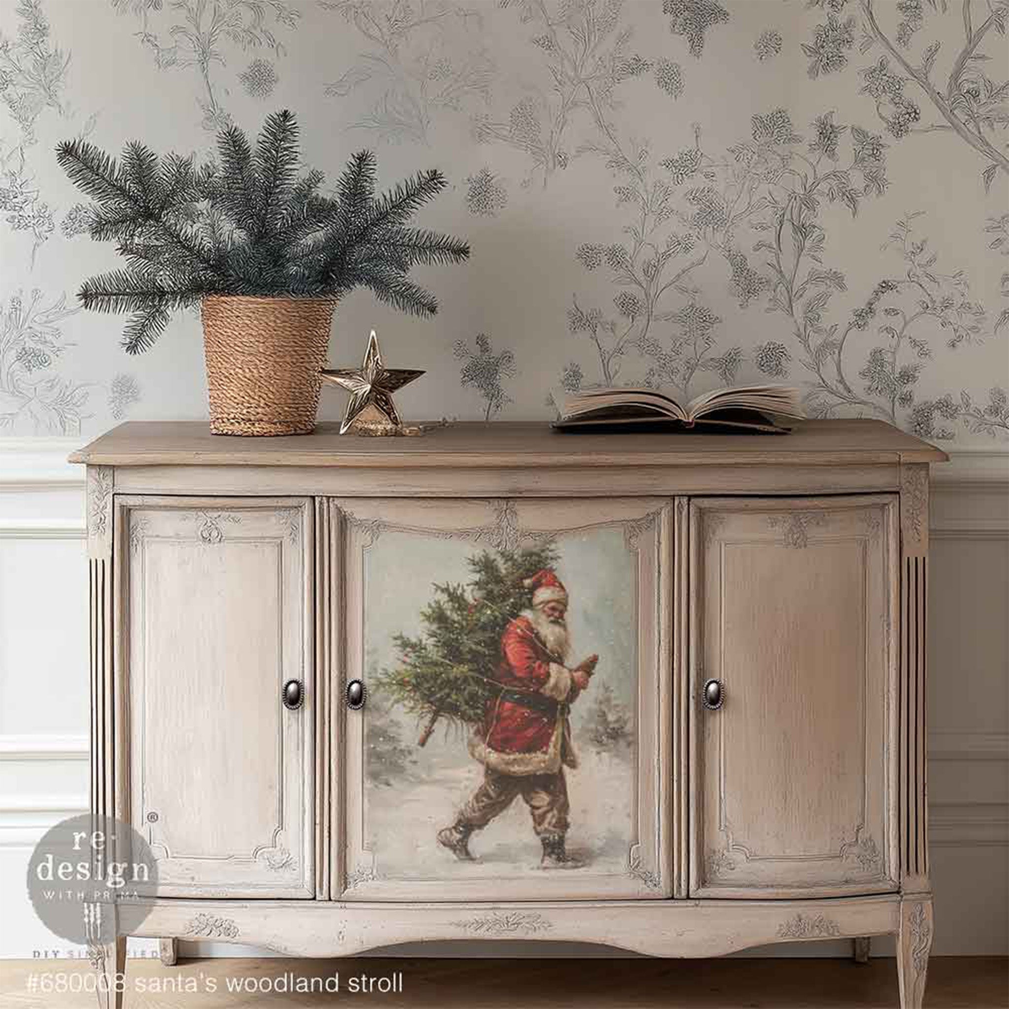 A vintage buffet cabinet is natural wood with white wash paint and features 1 design of Santa from ReDesign with Prima's Santas Woodland Stroll A3 fiber paper in the center door.