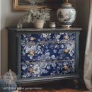 Blue floral-patterned dresser with gold knobs in a room setting.