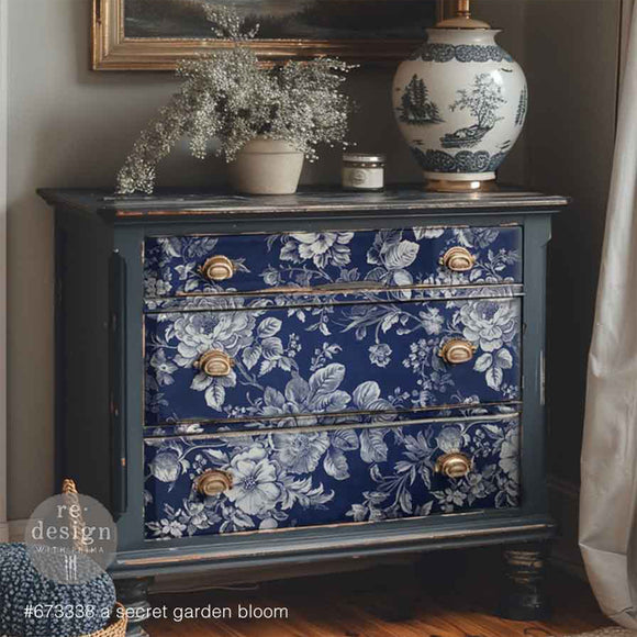 Blue floral-patterned dresser with gold knobs in a room setting.
