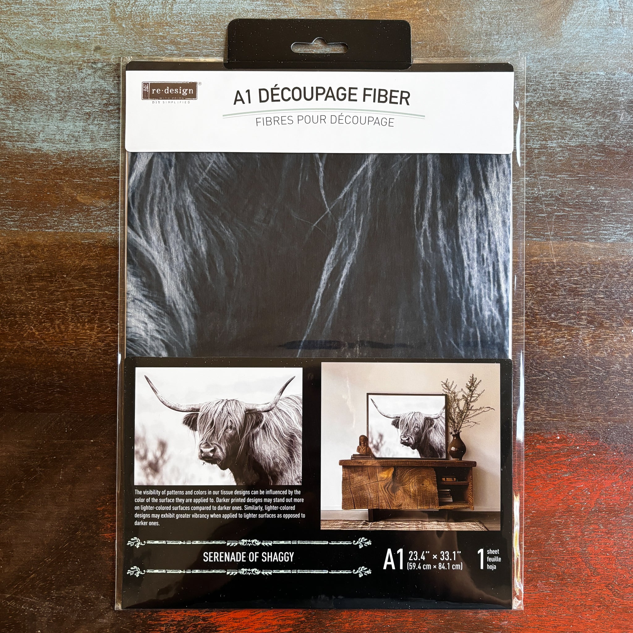 A package of ReDesign with Prima's Serenade of Shaggy fiber paper is against a dark wood background.