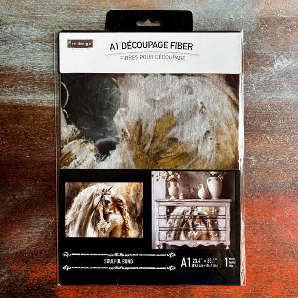 A package of ReDesign with Prima's Soulful Bond A1 fiber paper is against a dark wood background.