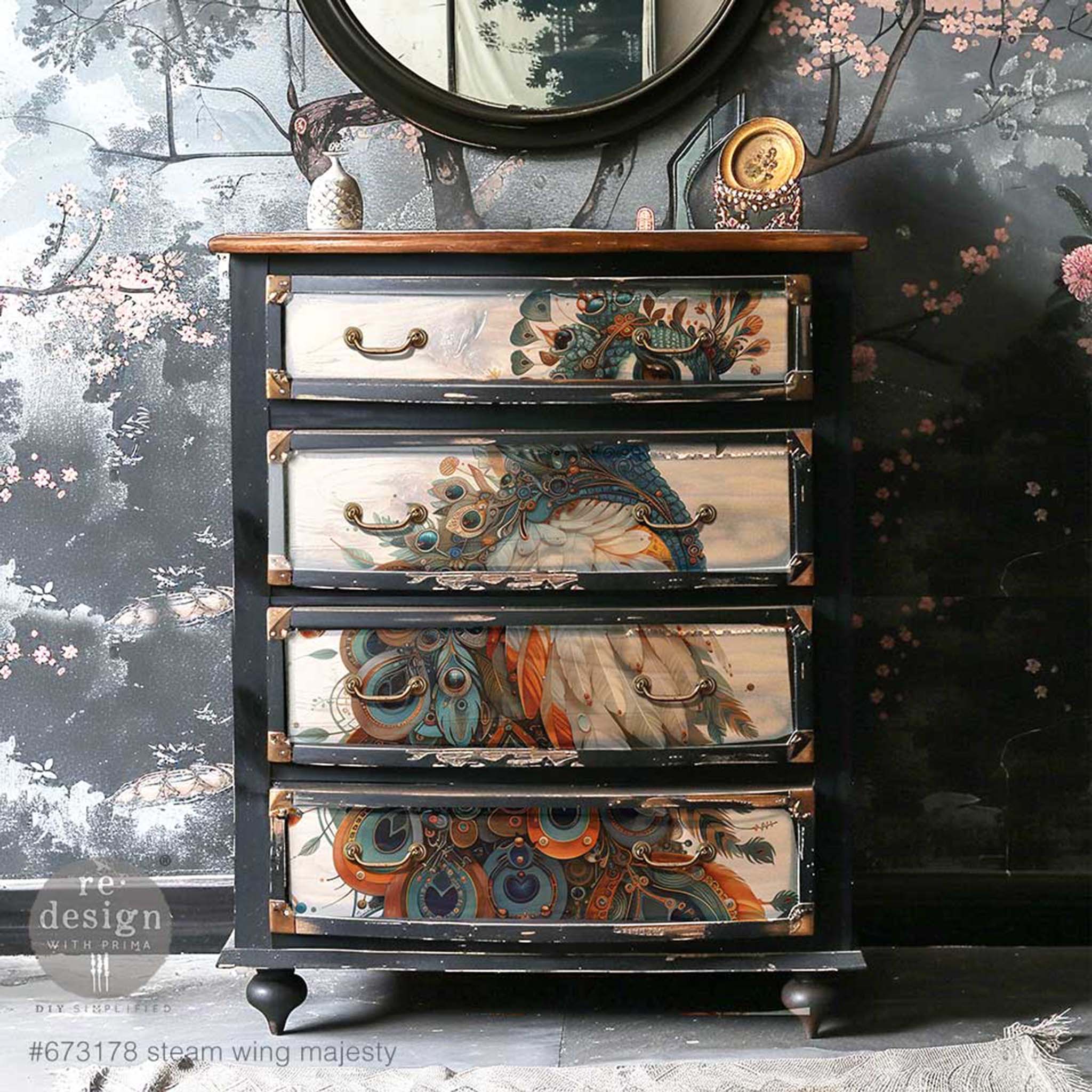 A vintage 4-drawer dresser is painted black and features ReDesign with Prima's Steam Wing Majesty A1 fiber paper on its drawers.