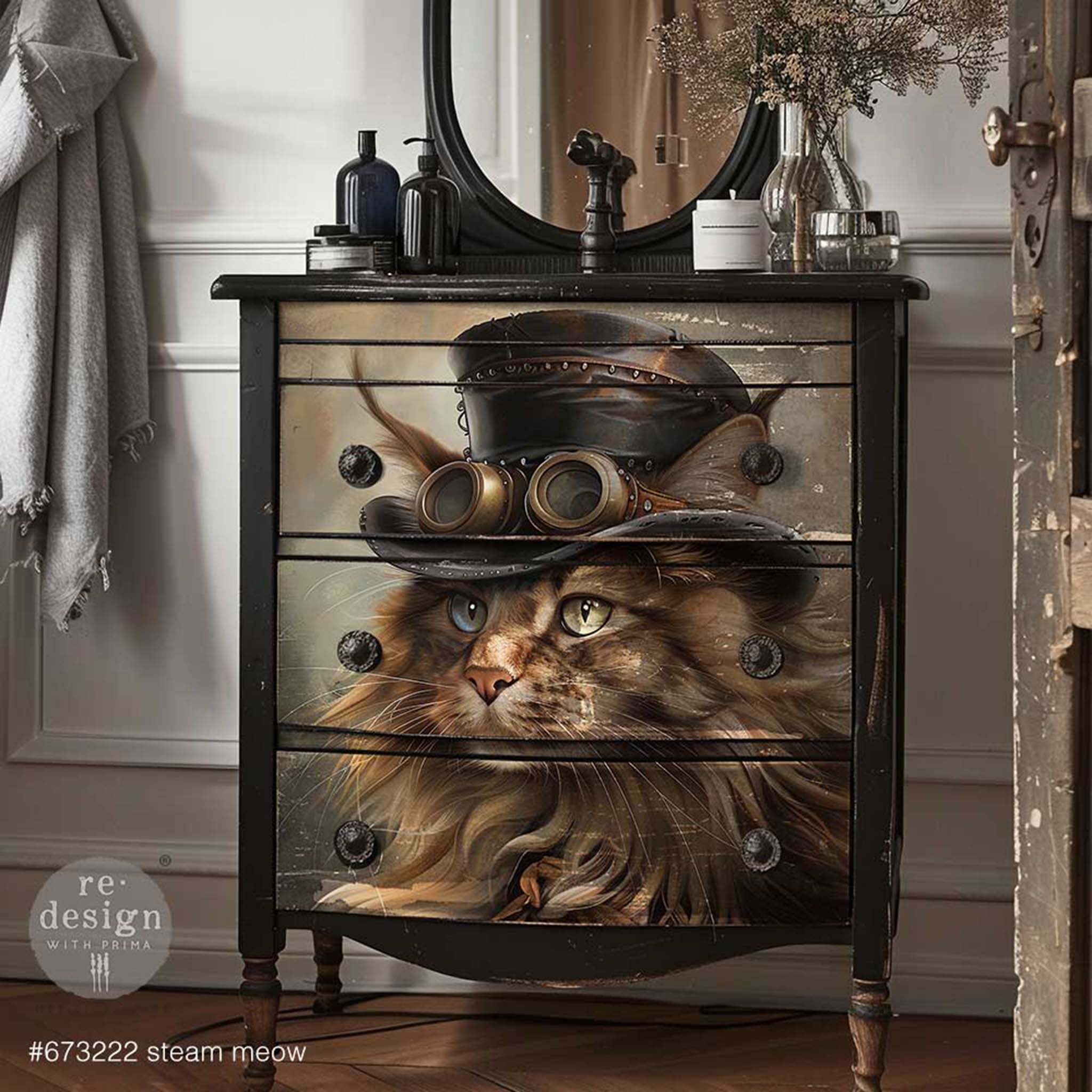 A vintage 3-drawer dresser is painted black and features ReDesign with Prima's Steam Meow A1 fiber paper on the drawers.