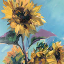 Close-up of an A1 fiber paper featuring a painting of large bold sunflowers blooming against a beautiful blue sky. 