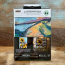 A package of ReDesign with Prima's Sunshine Embrace A1 Fiber Paper is against a wood background.