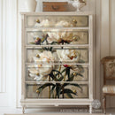 A 5-drawer chest dresser is painted white and features ReDesign with Prima's The Art of Blooming A1 Fiber paper on its drawers.