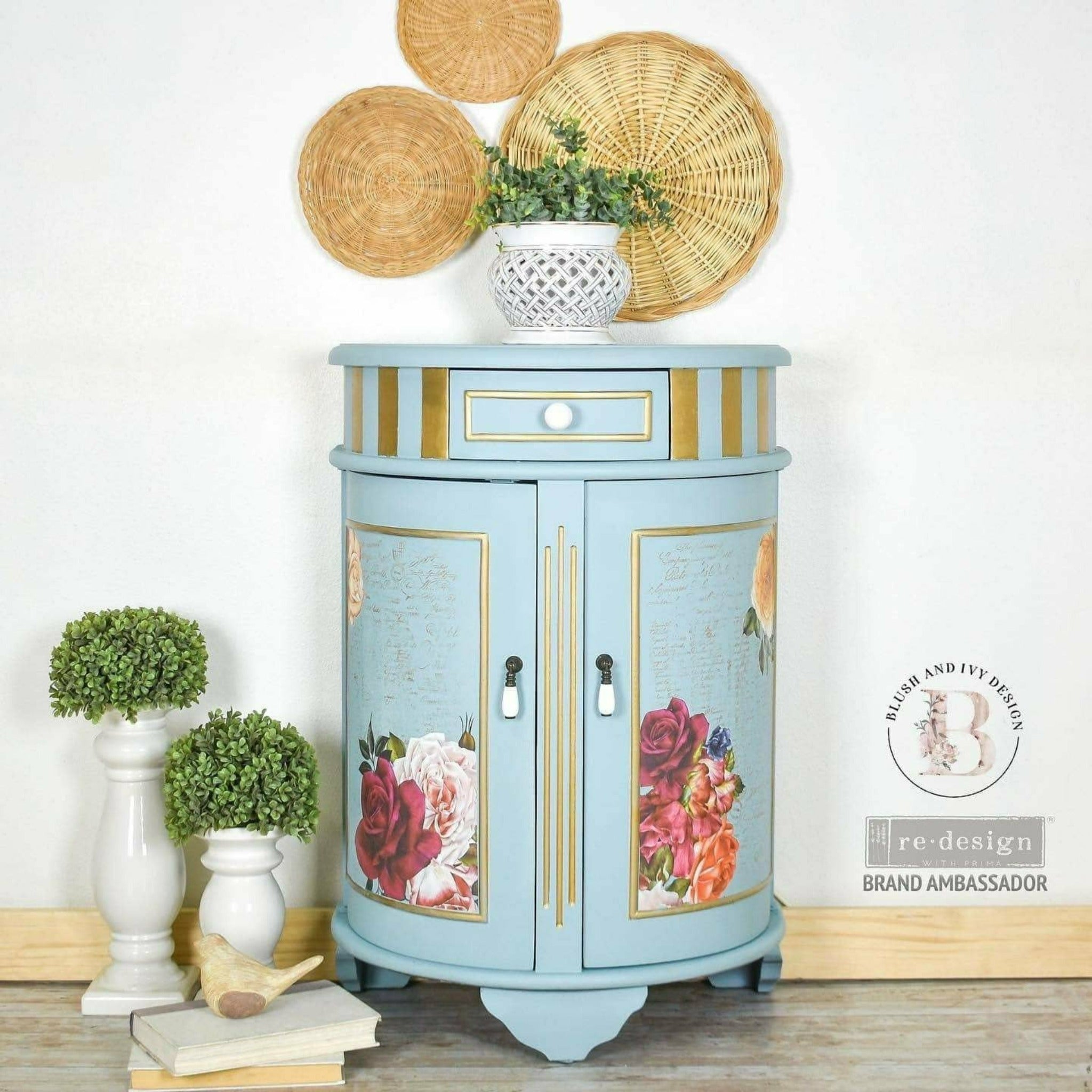 A vintage half circle side table with storage refurbished by Blush and Ivy Design s painted pale blue with gold accents and features ReDesign with Prima's Beautiful Things rub on transfer on its 2 doors.