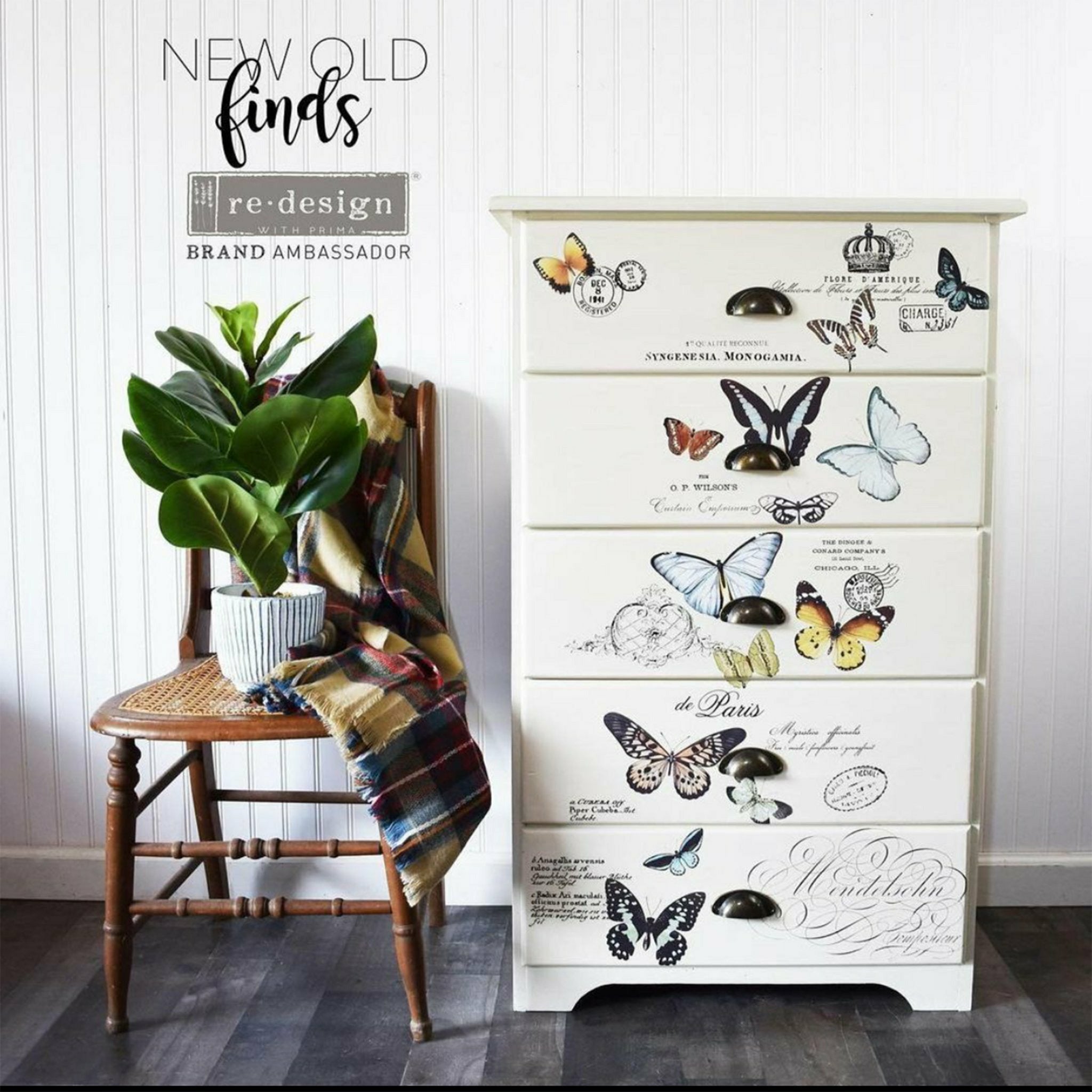 A 5-drawer chest dresser refurbished by New Old Finds is painted soft white and features ReDesign with Prima's Butterfly Dance rub on transfer on the drawers.