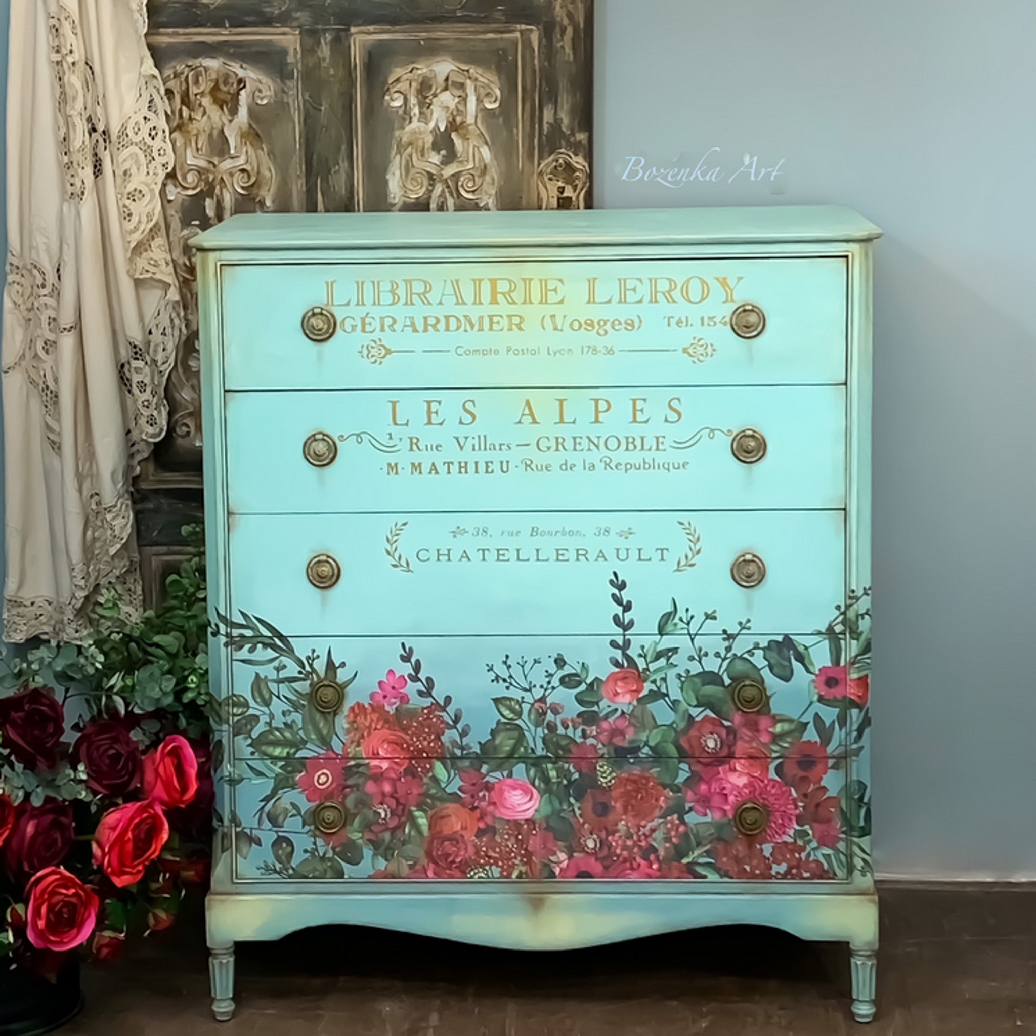 A vintage 5-drawer chest dresser refurbished by Bozenka Art is painted sky blue and features ReDesign with Prima's Earthly Delights rub on transfer on the bottom 2 drawers.