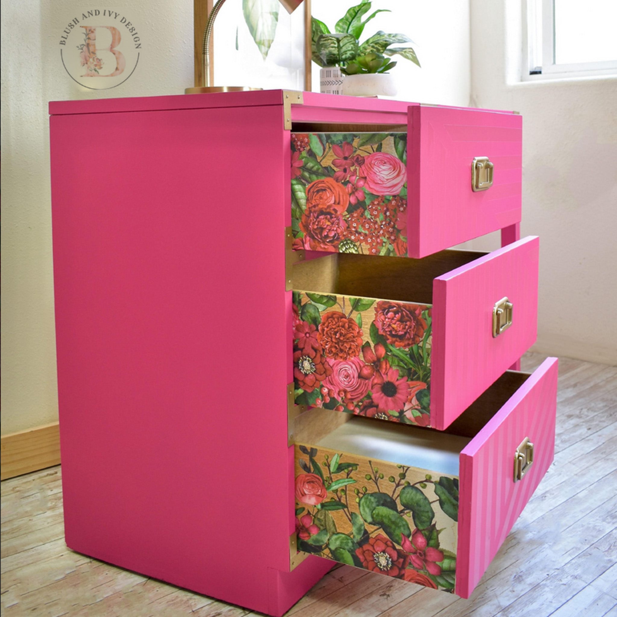 A 3-drawer dresser refurbished by Blush and Ivy is painted pink and features ReDesign with Prima's Earthly Delights rub on transfer on the sides of the drawers. 