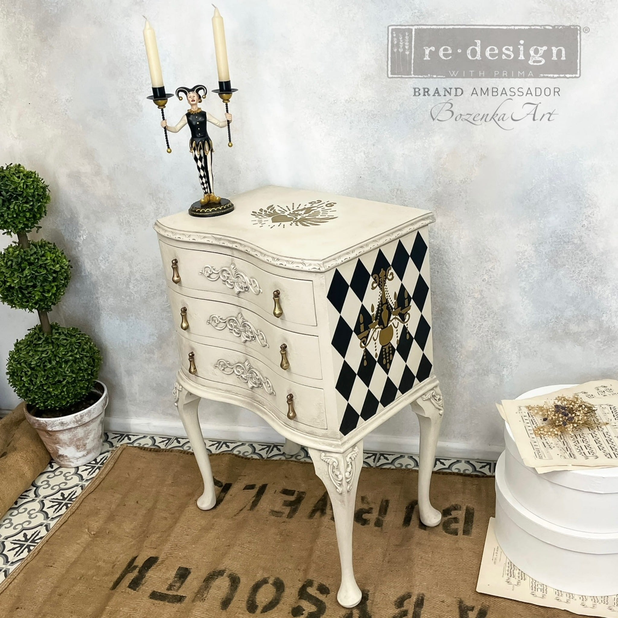 A vintage 3-drawer nightstand refurbished by Bozenka Art is painted off-white and features the Harlequin transfer on its sides.