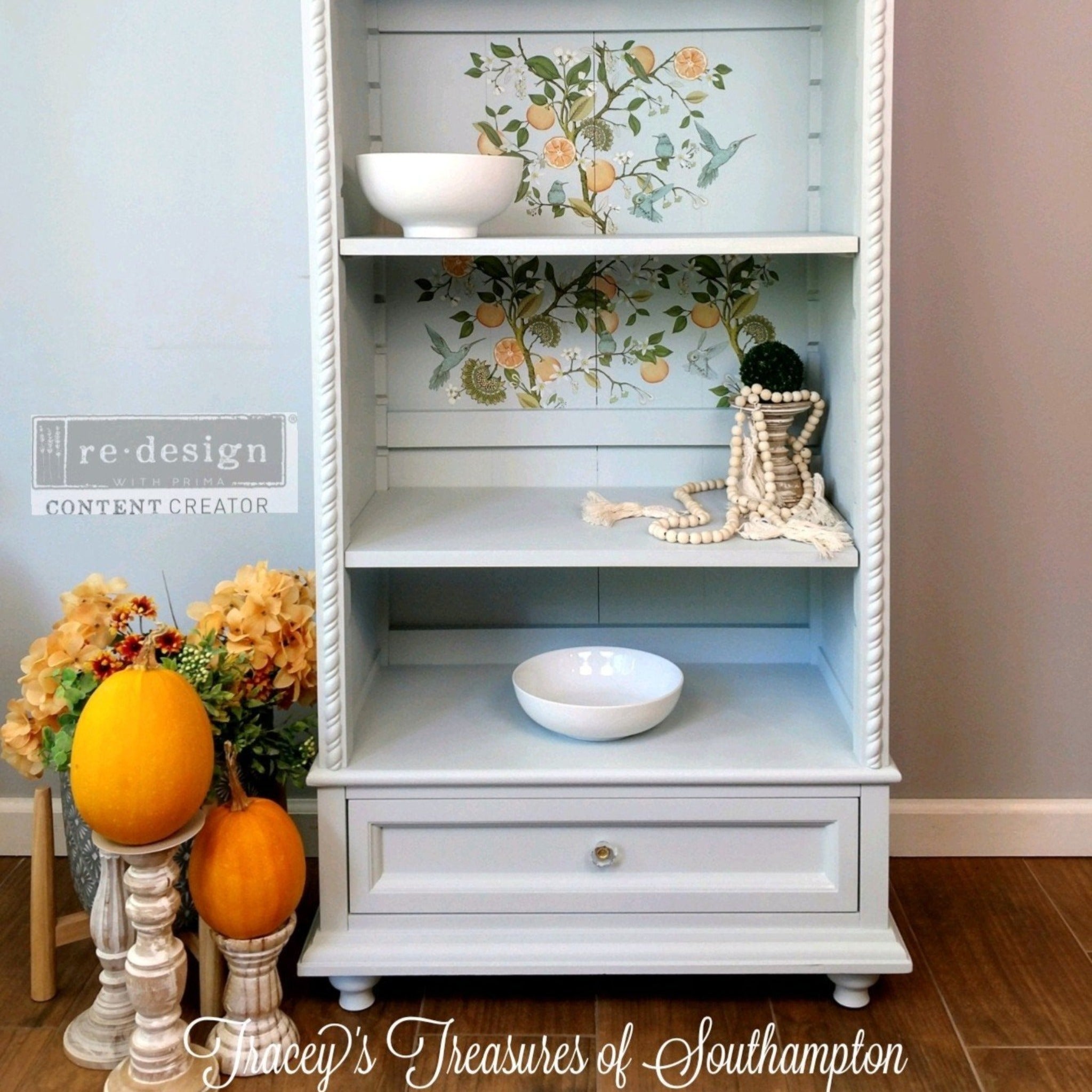 A tall vintage bookcase refurbished by Tracey's Treasures of Southampton is painted white and features ReDesign with Prima's Orange Grove transfer on the inside backboard.