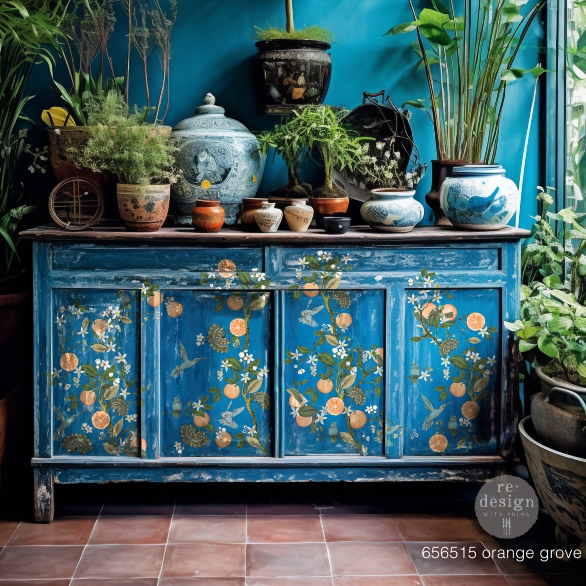 A large buffet cabinet is painted blue and features ReDesign with Prima's Orange Grove transfer on the front.