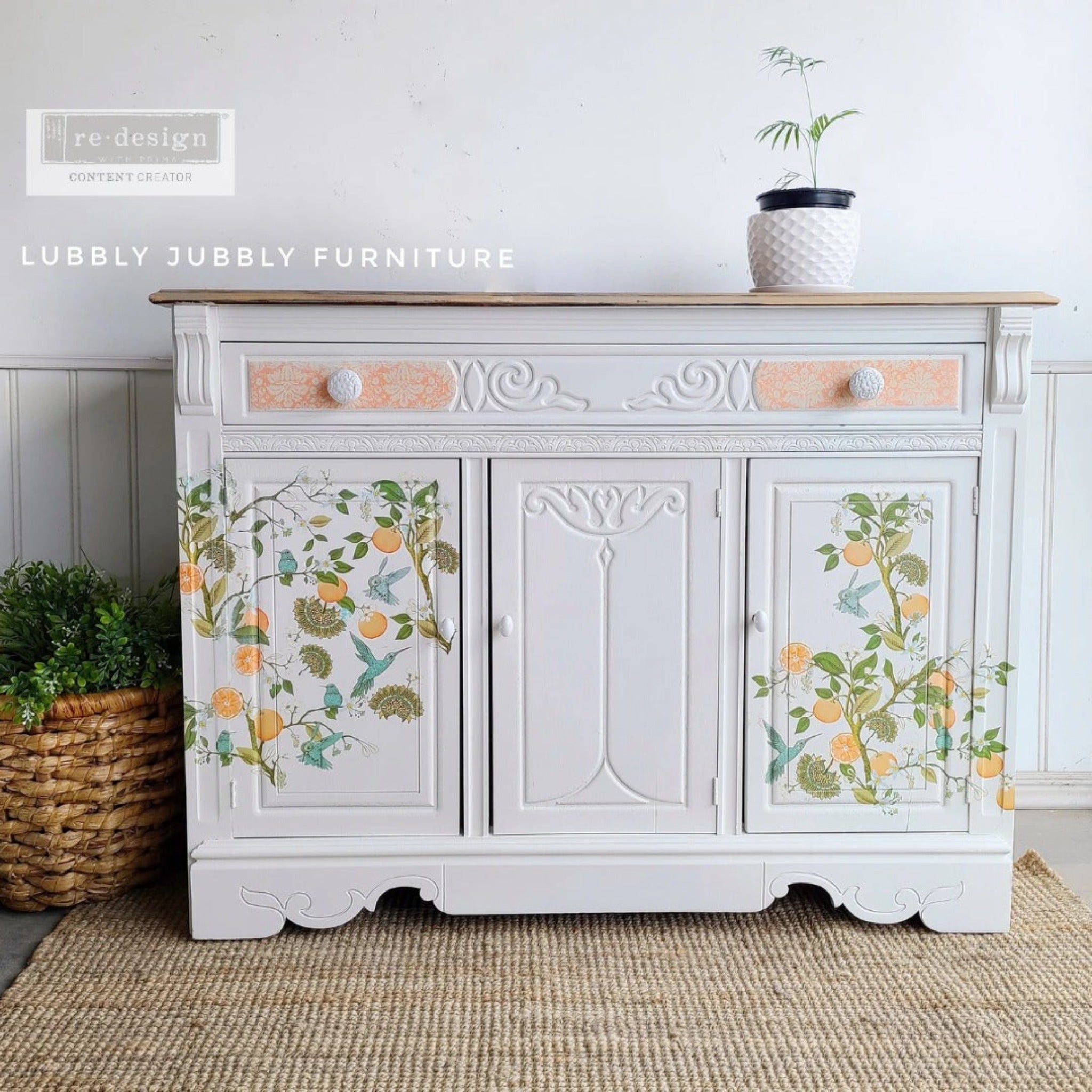 A buffet cabinet refurbished by Luibbly Jubbly Furniture is painted white and features ReDesign with Prima's Orange Grove transfer on the front on 2 doors.