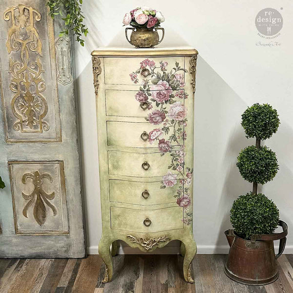 Tall lingerie chest makeover with Blushing Blooms Symphony furniture transfer—vertical rose and greenery arrangement down the right side on a distressed cream-and-green finish.