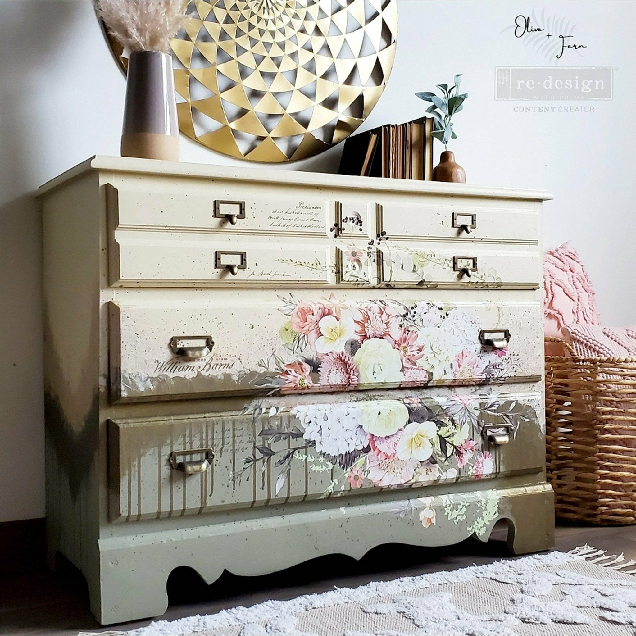 A large 4-drawer dresser refurbished by Olive & Fern is painted a combination of cream, soft brown, and medium grey and features ReDesign with Prima's Life in Full Bloom rub on transfer on it. 