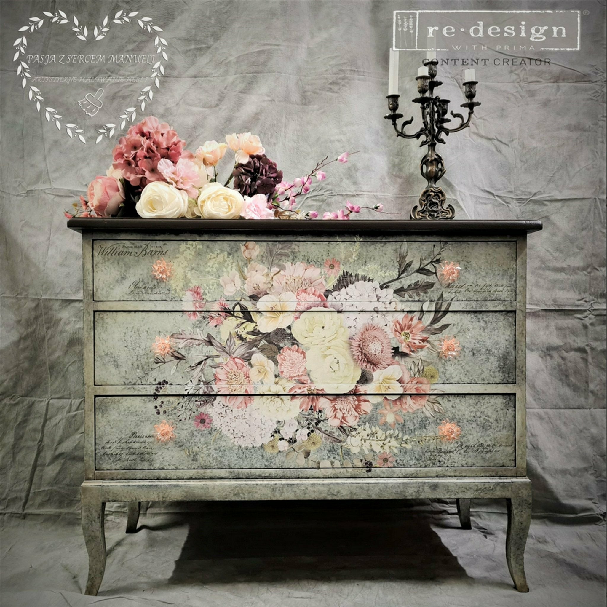 A large 3-drawer dresser refurbished by Pasja Z Sercem Manueli is painted a mottled grey and features ReDesign with Prima's Life in Full Bloom rub on transfer on it.