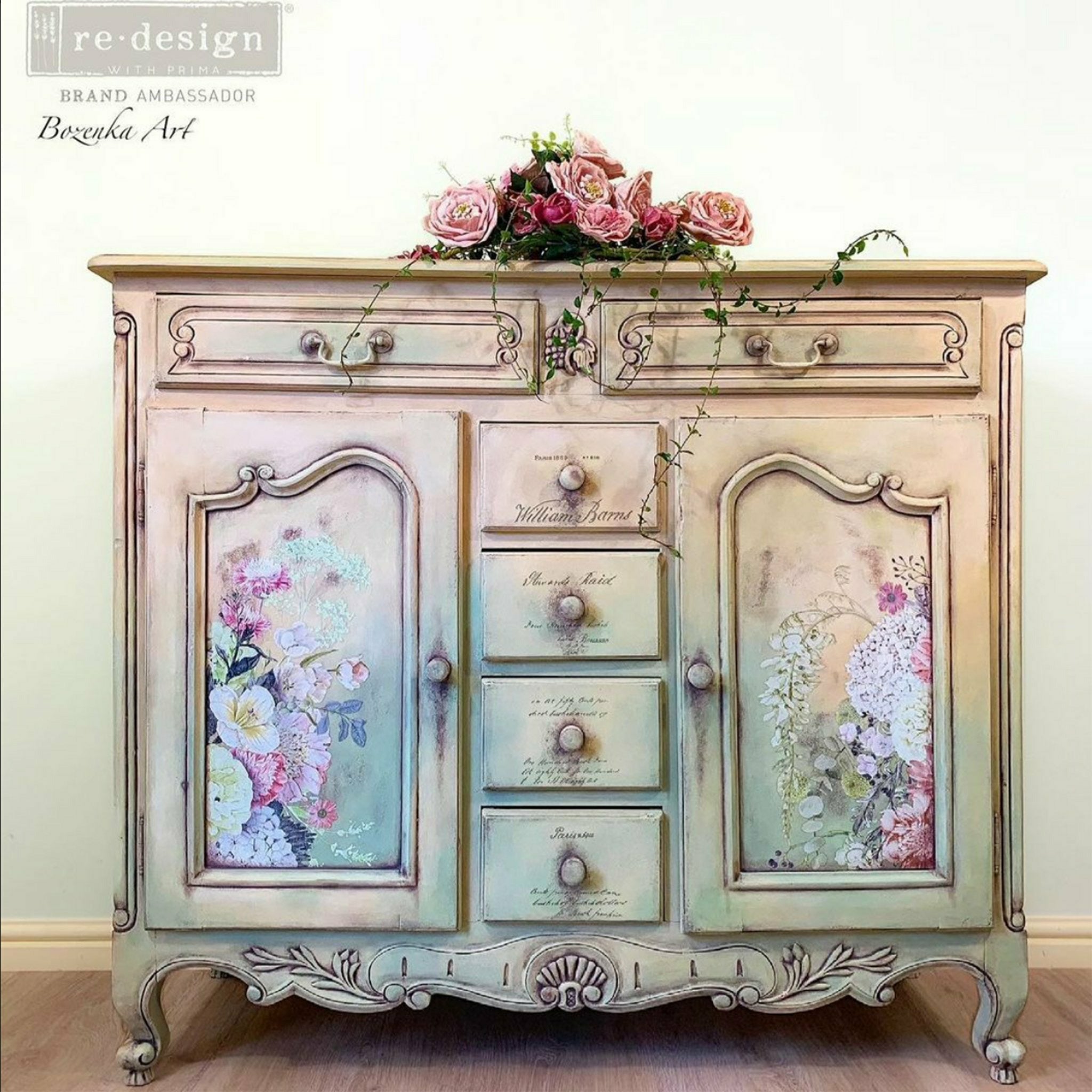 A vintage small buffet cabinet refurbished by Bozenka Art is painted soft pink and blue and features ReDesign with Prima's Life in Full Bloom rub on transfer on it.