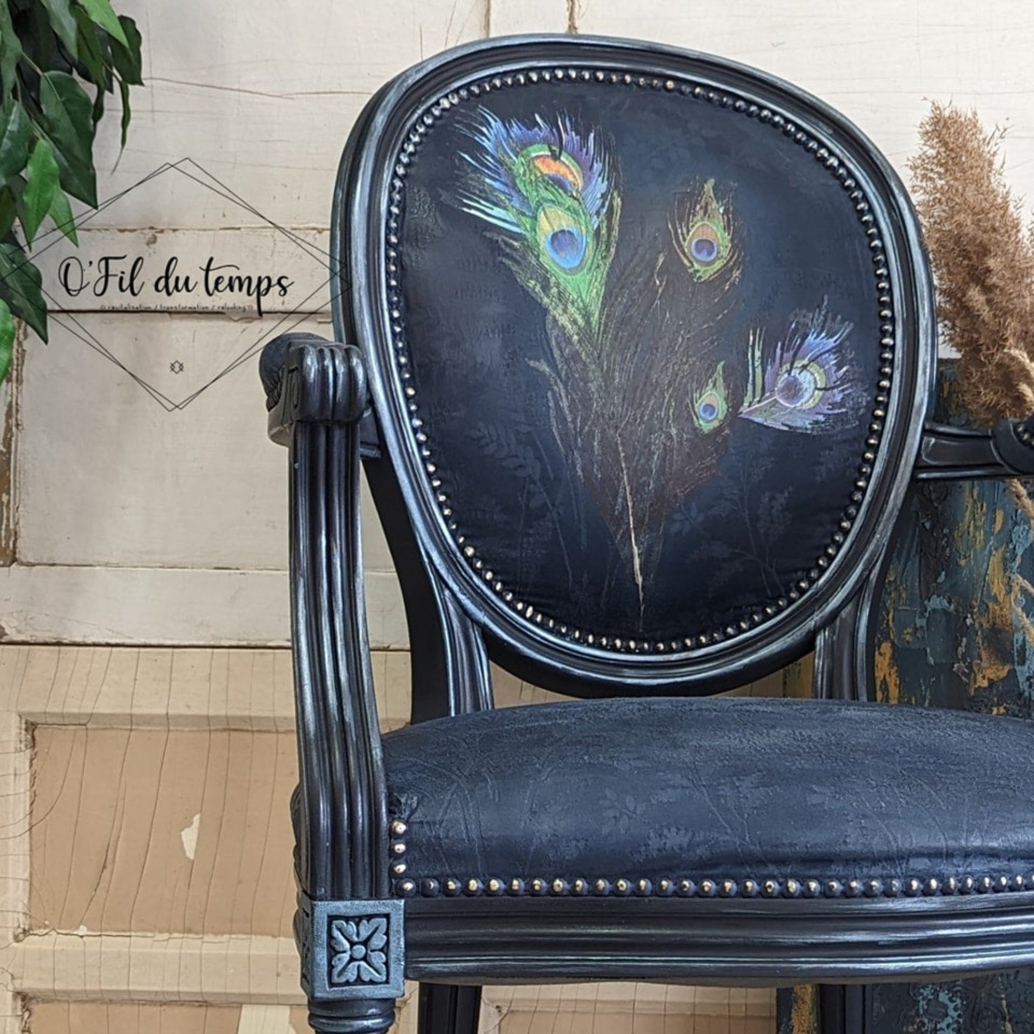 A vintage chair refurbished by O'Fil du Temps is painted dark blue and features ReDesign with Prima's Peacock Dreams transfer on the back.