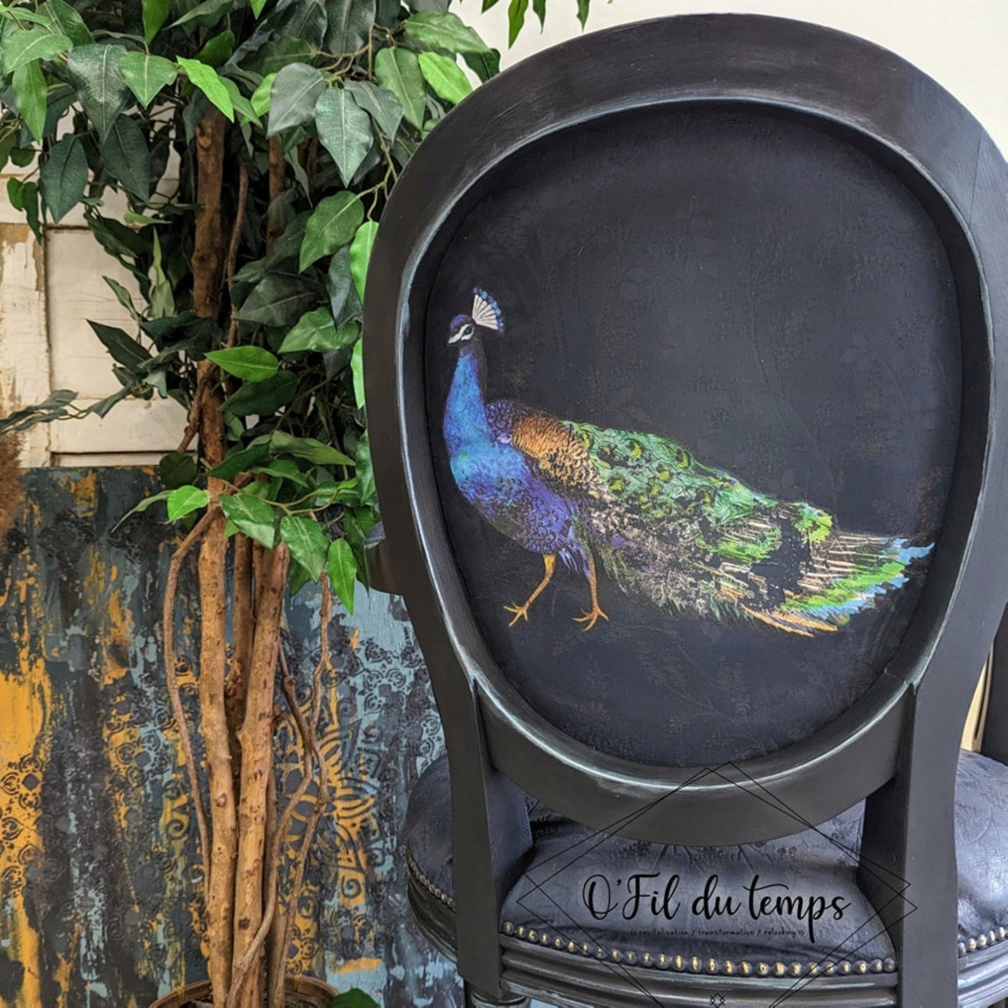 A vintage chair refurbished by O'Fil du Temps is painted dark blue and features ReDesign with Prima's Peacock Dreams transfer on the backside.