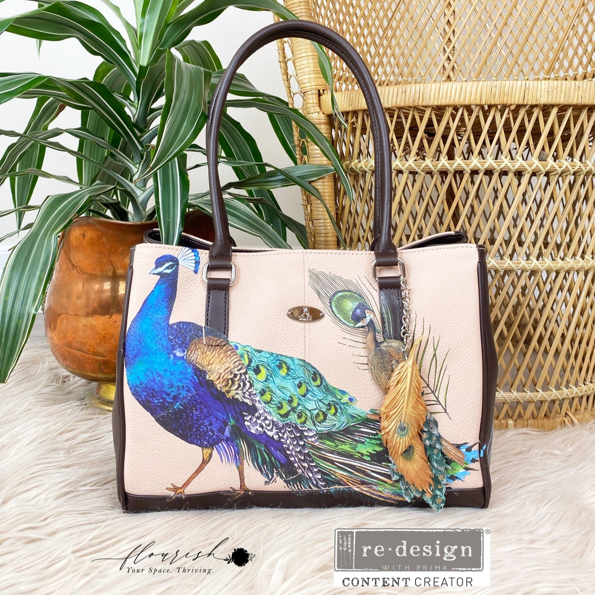 A leather handbag refurbished by Flourish Your Space Thriving features ReDesign with Prima's Peacock Dreams transfer on it.