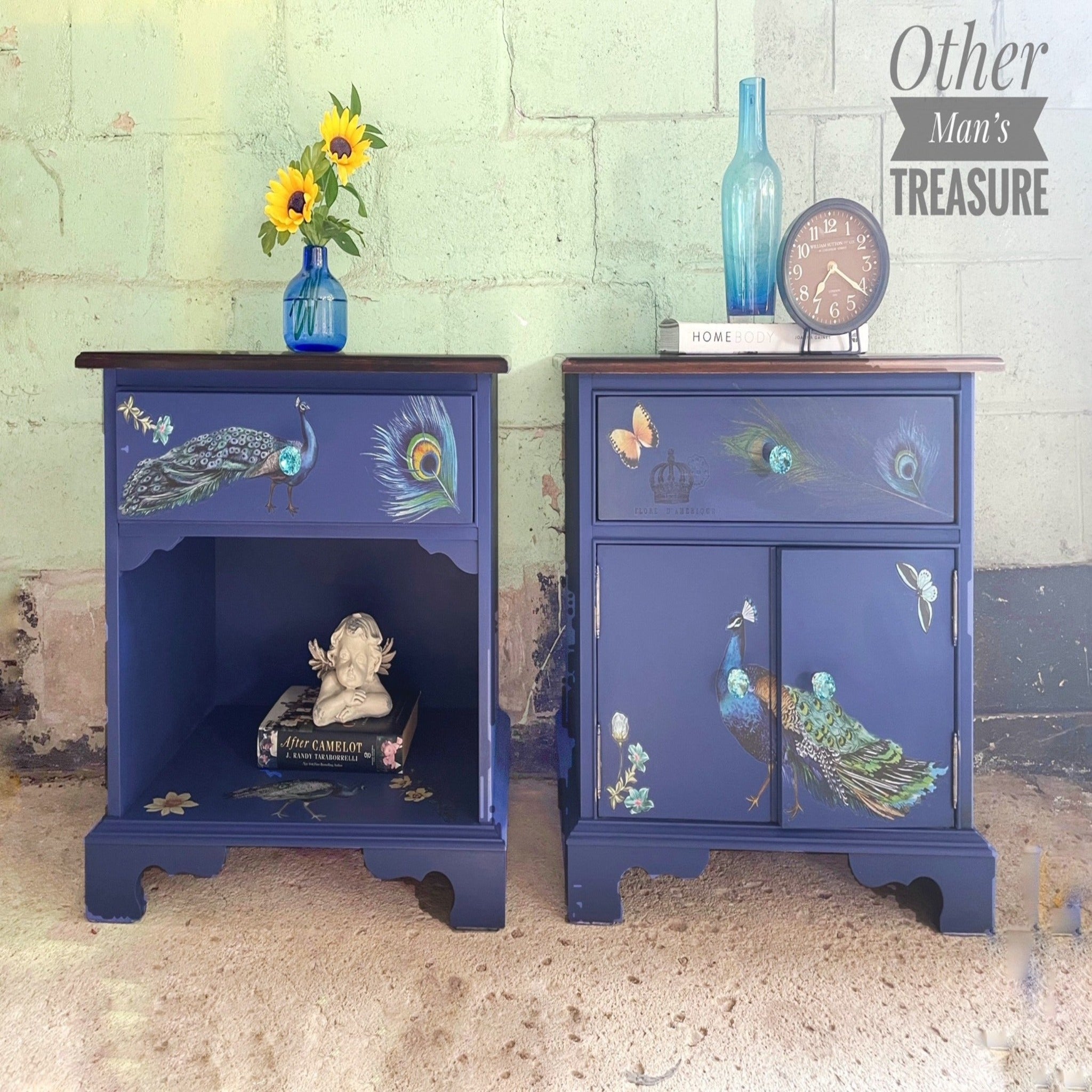 Two vintage nightstands refurbished by Other Man's Treasure are painted dark blue and feature ReDesign with Prima's Peacock Dreams transfer on them.