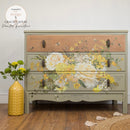 Full dresser mockup featuring the Sunlit Serenade furniture transfer by ReDesign with Prima across the center drawers—creamy roses, golden blooms, French script, and bees—styled with a yellow vase on a wood floor